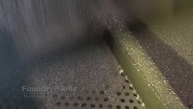 Blasting gravel and sand from blast cleaning chamber