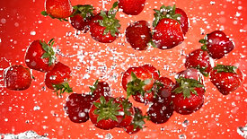 fresh strawberries flying in the air with water splashes